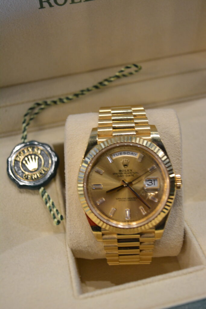 Rolex DayDate 40 Champagne Dial with Diamond Markers.