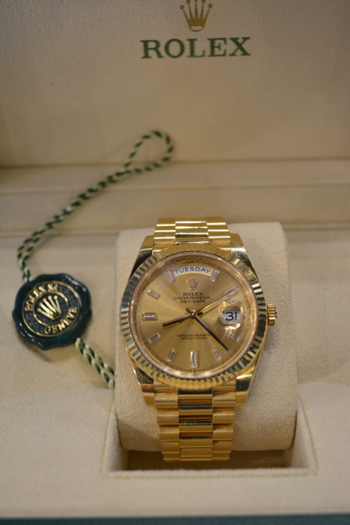 Rolex DayDate 40 Champagne Dial with Diamond Markers.
